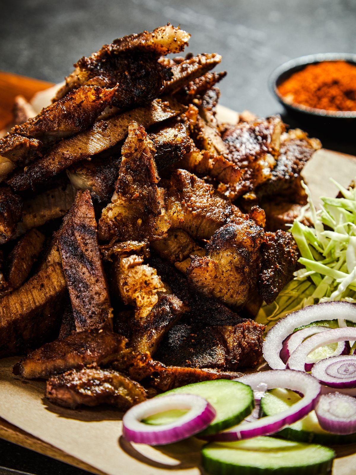 Spicy grilled ram suya with onions and peppers